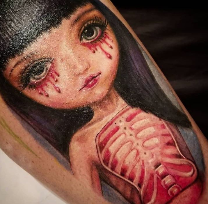 Creepy big eyes doll with glowing heart and bloody tears tattoo 